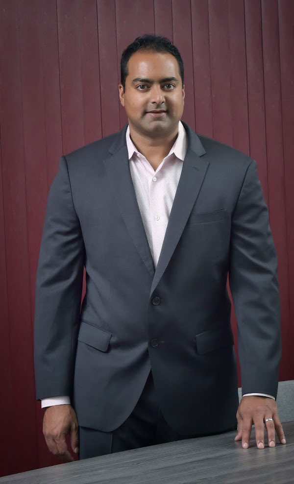 Dr. Rajiv Sood posing in conference room